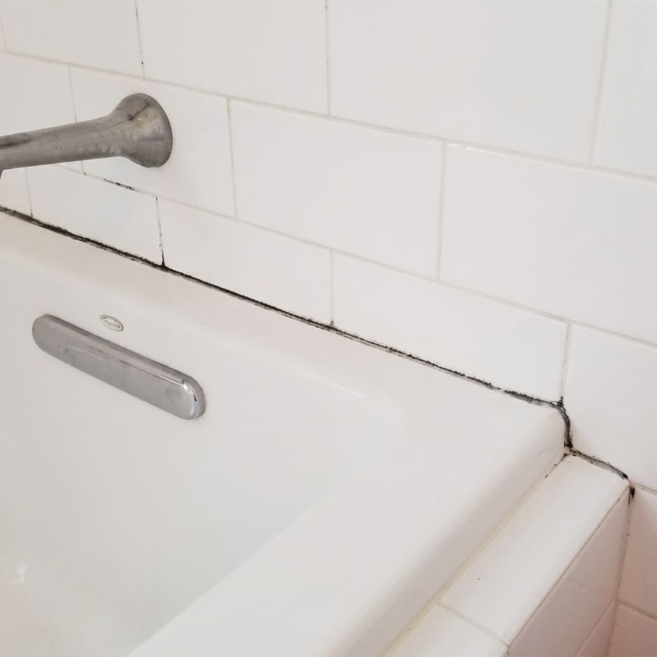 Before bathtub wall joint re-caulking in Brampton.