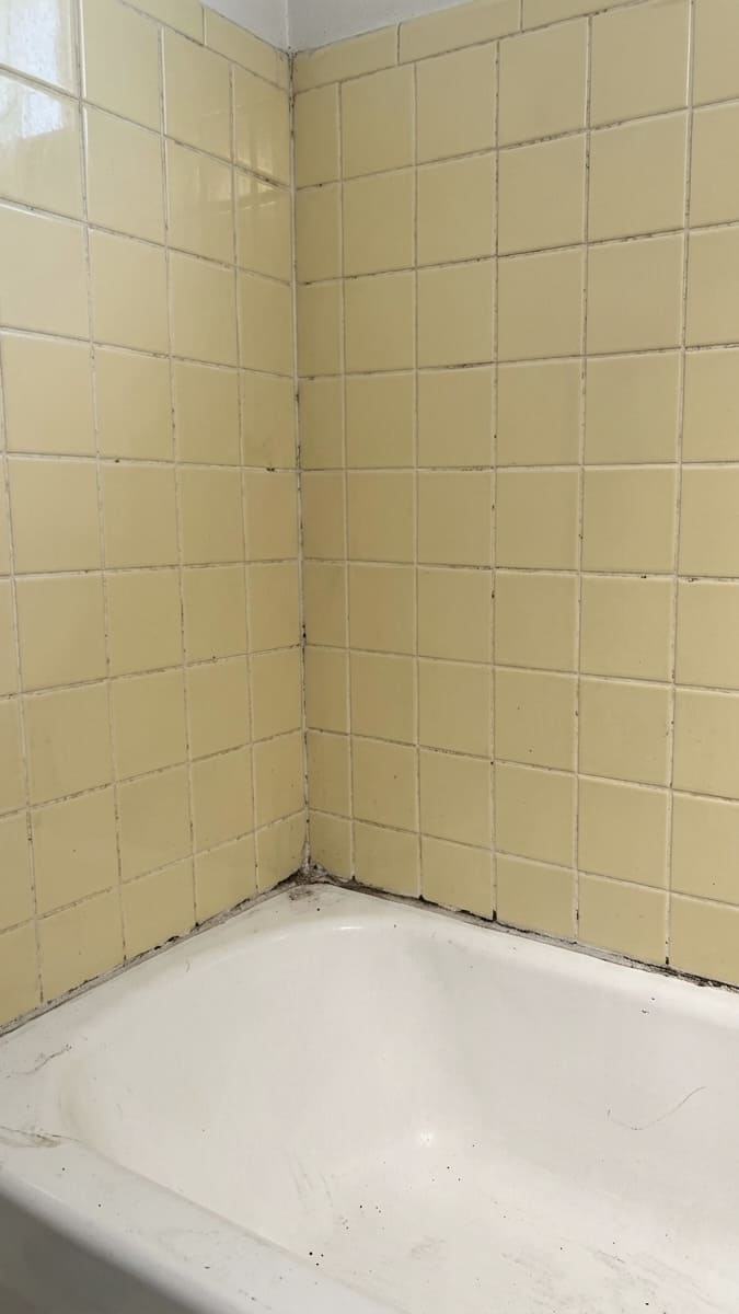Before bathtub corner re-caulking in Markham.