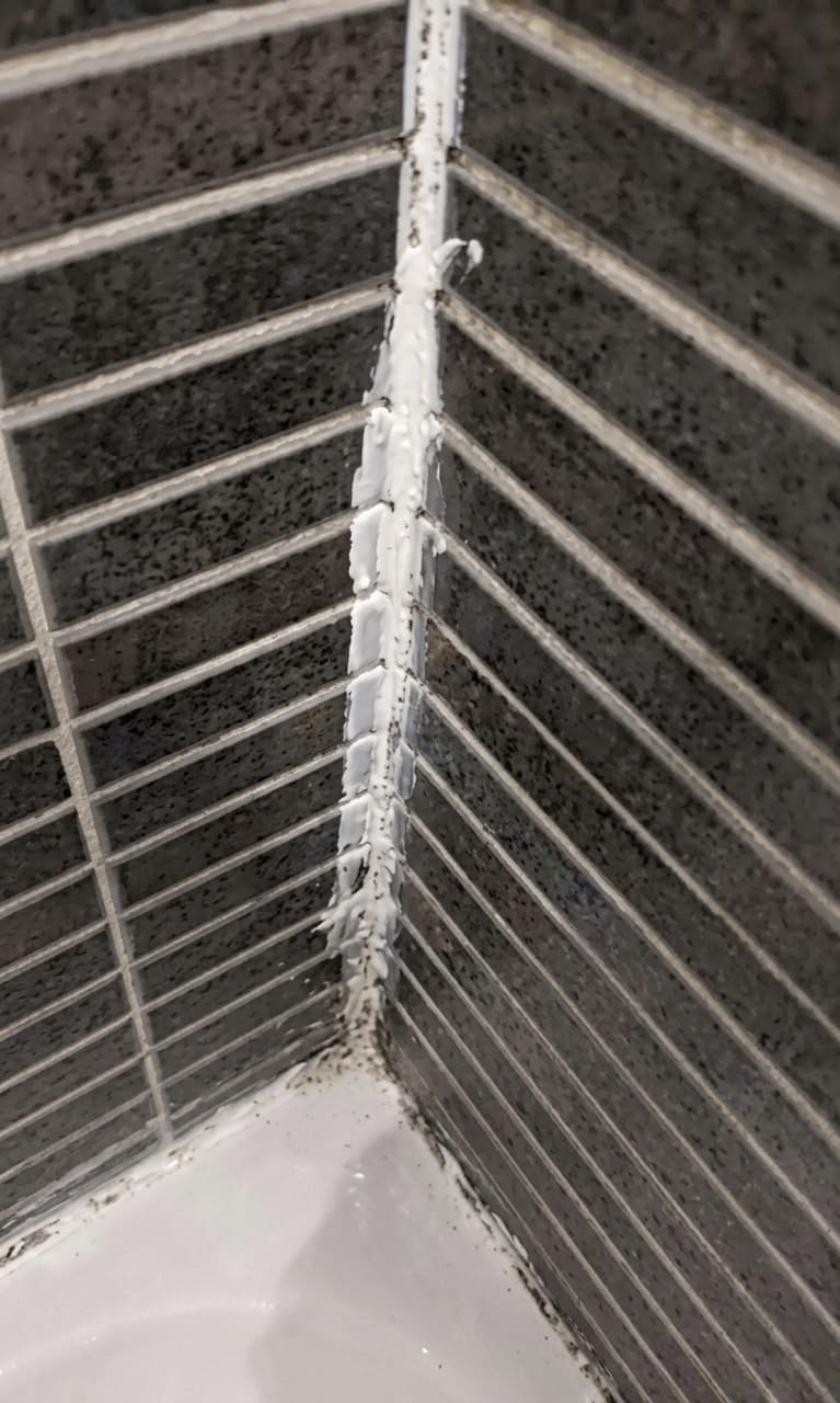 Before bathtub corner joint re-caulking in Mississauga.