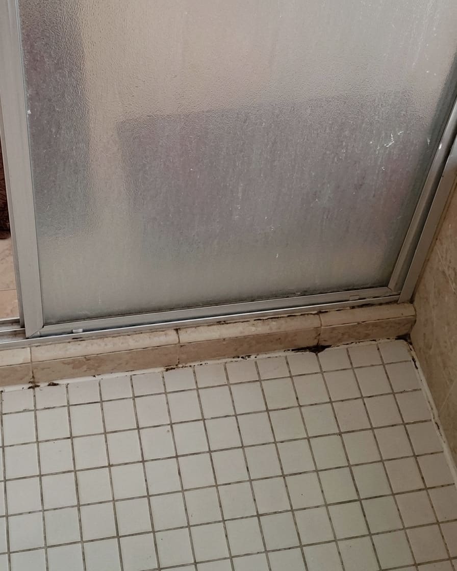 Before shower glass base re-caulking in Mississauga.