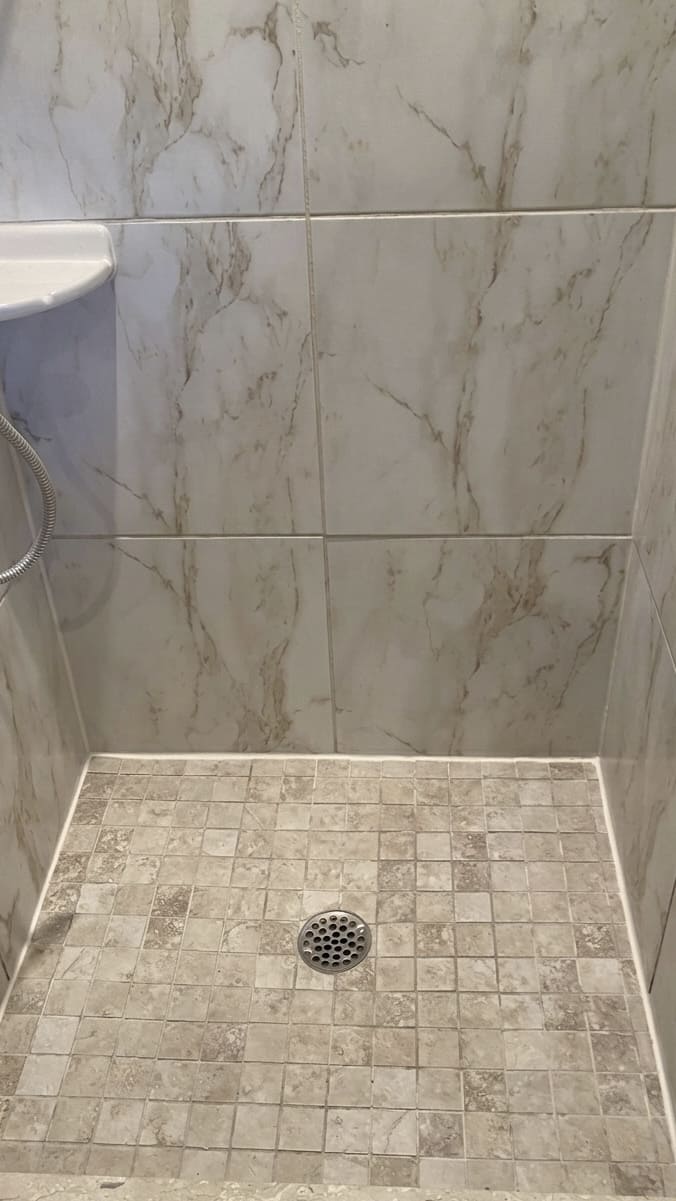 After shower base perimeter re-caulking in Oakville.