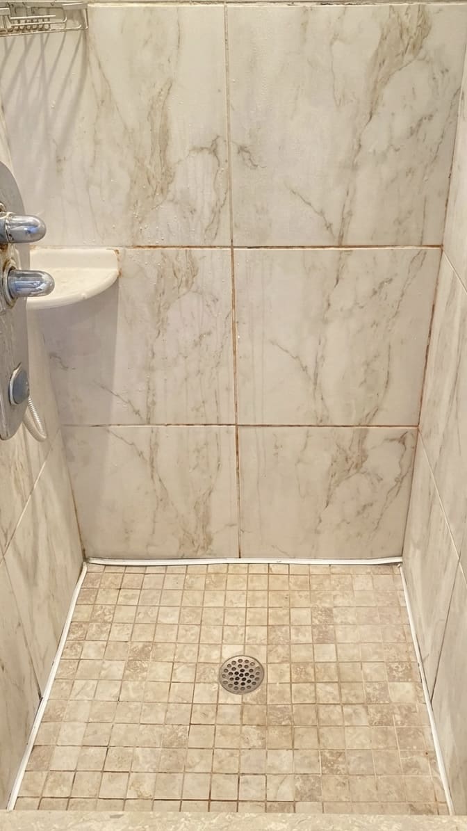 Before shower base perimeter re-caulking in Oakville.
