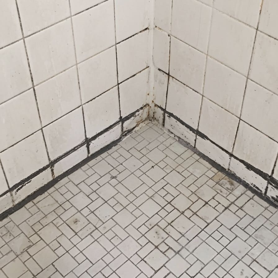 Before shower floor corner re-caulking in Oakville.