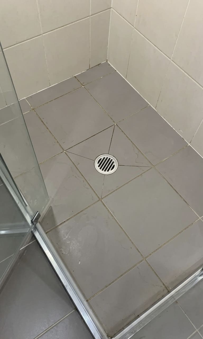 Before condo shower floor re-caulking in Toronto.