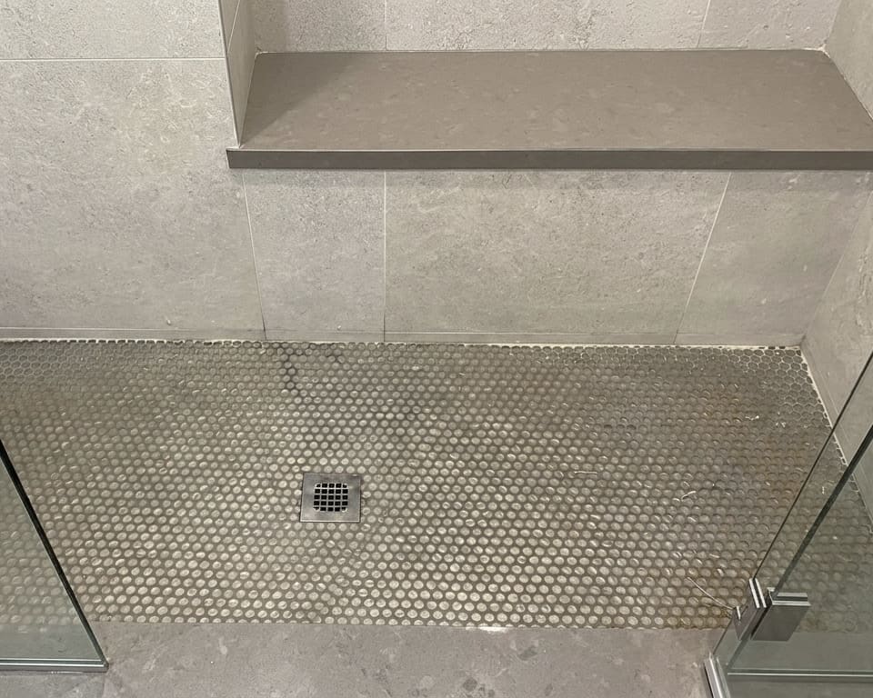 Before shower base perimeter re-caulking in Toronto.