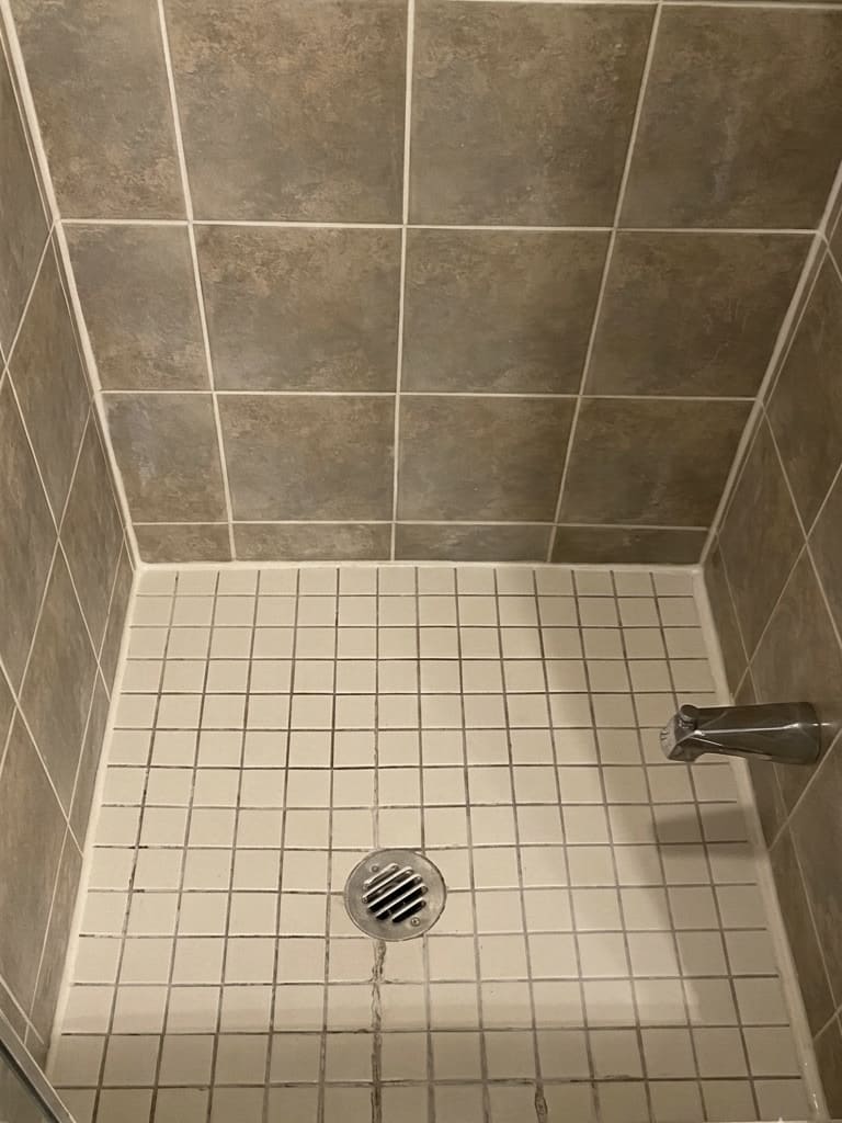 After shower floor corner re-caulking in Toronto.