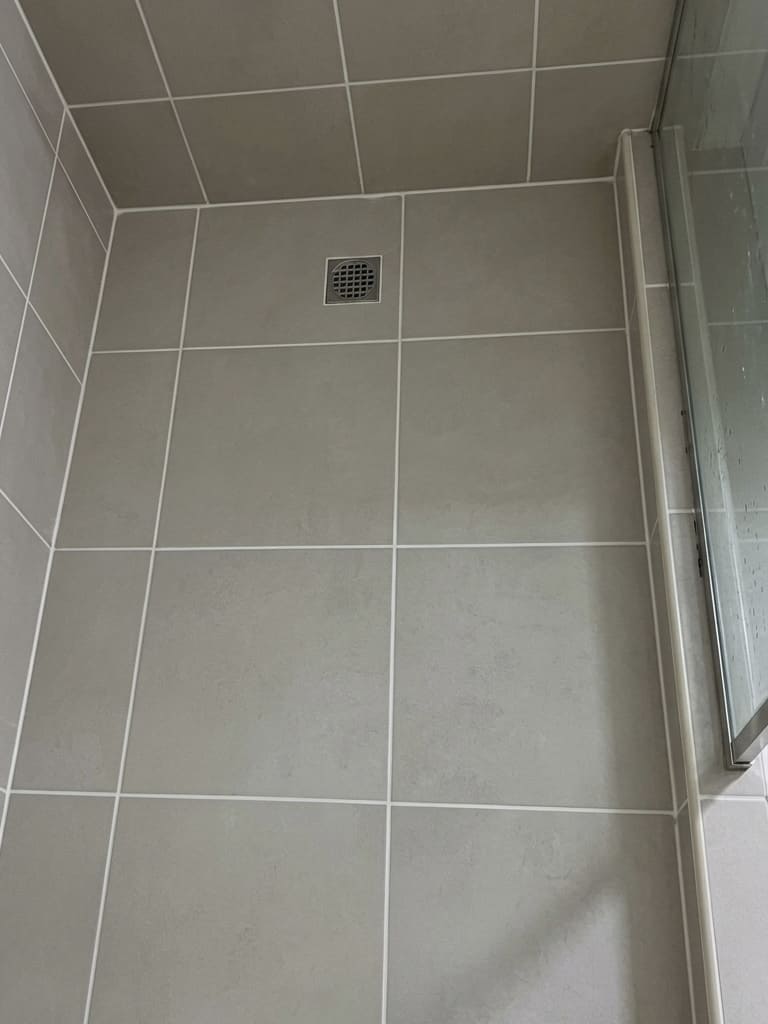 After shower floor perimeter re-caulking in Toronto.