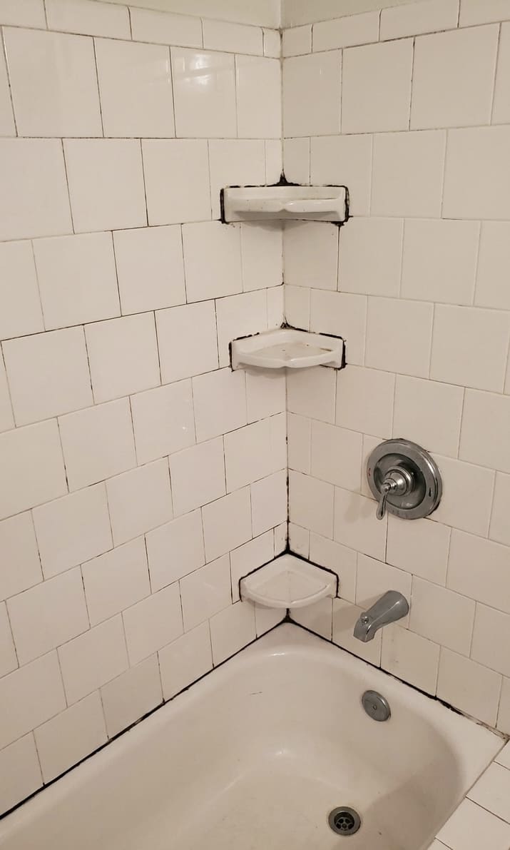 Before tub corner and shelf re-caulking in Vaughan.