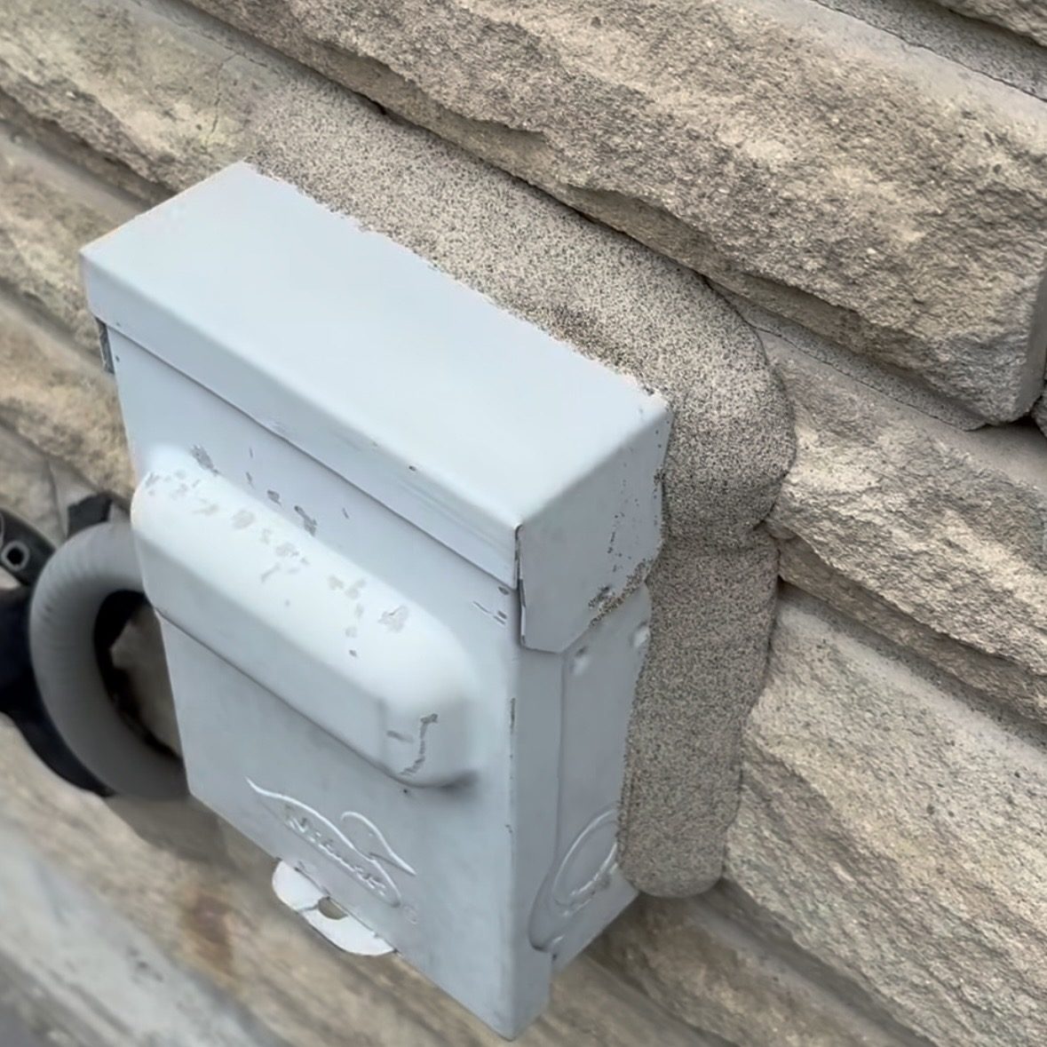 Mississauga exterior electrical box caulking with a sand-broadcast finish matched closer to the stone facade