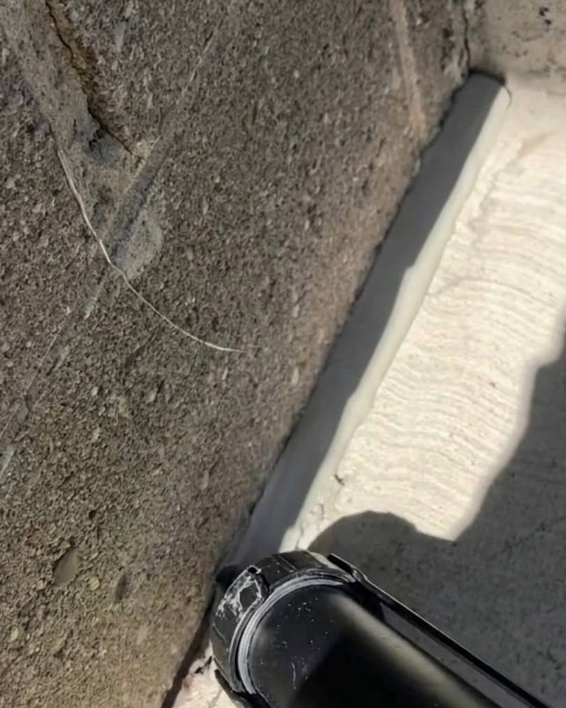 Applying foundation caulking in Oakville