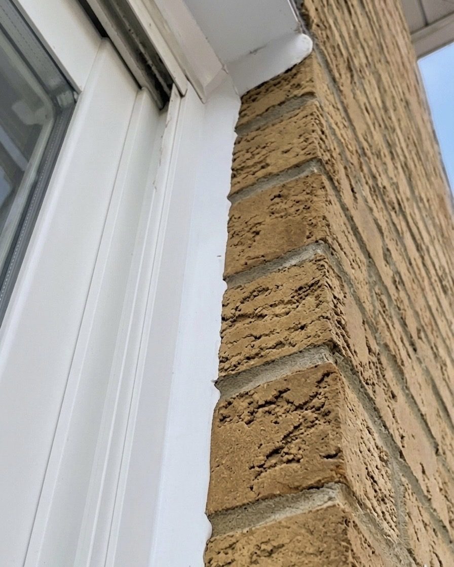 Finished window caulking line between the window and facade